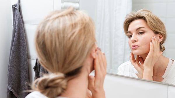 Woman looking at the mirror