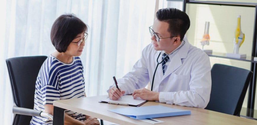 Doctor and woman consultation in a body check
